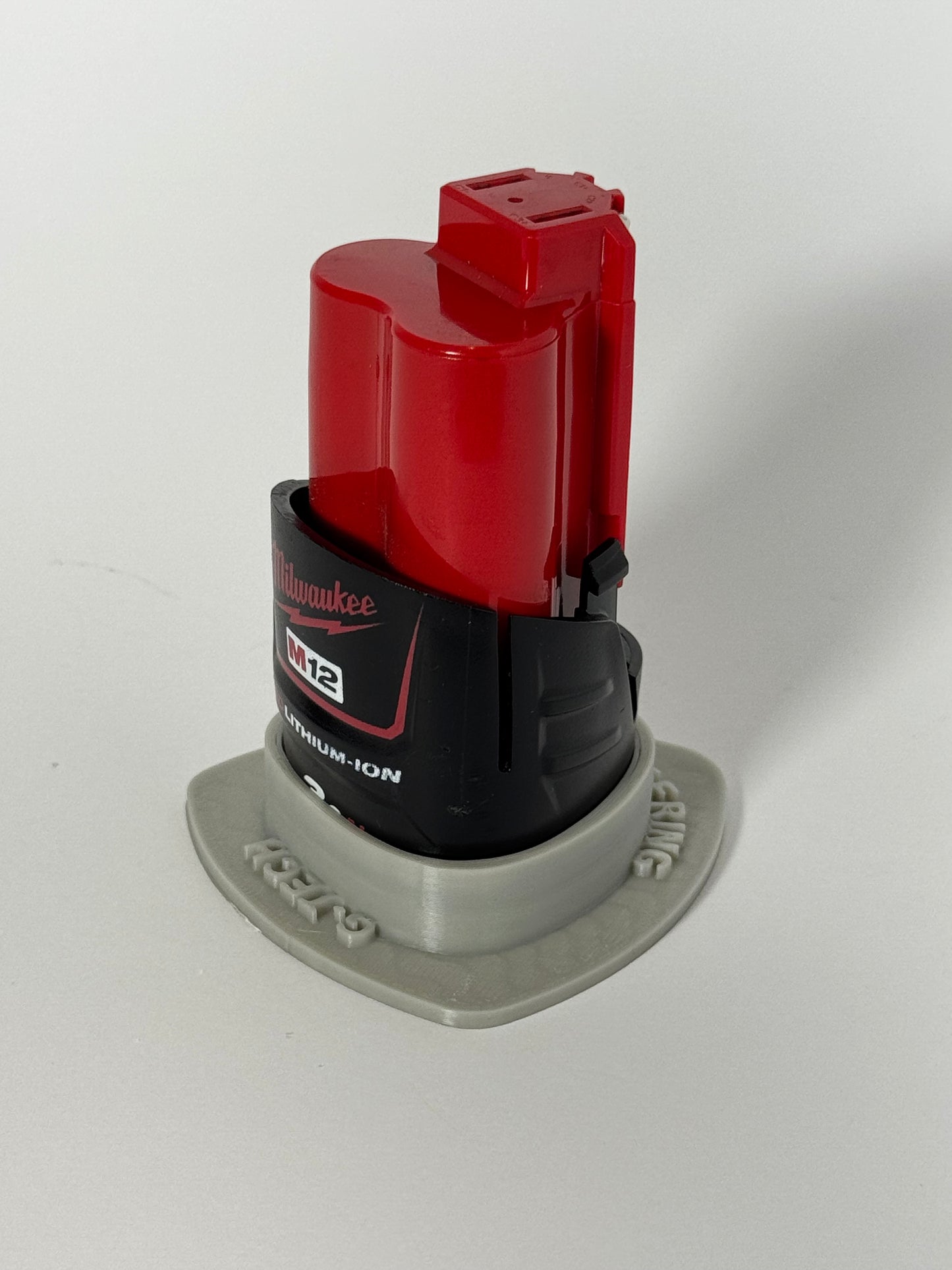 Magnetic storage base for Milwaukee M12 batteries, perfect for organizing tools and accessories.
