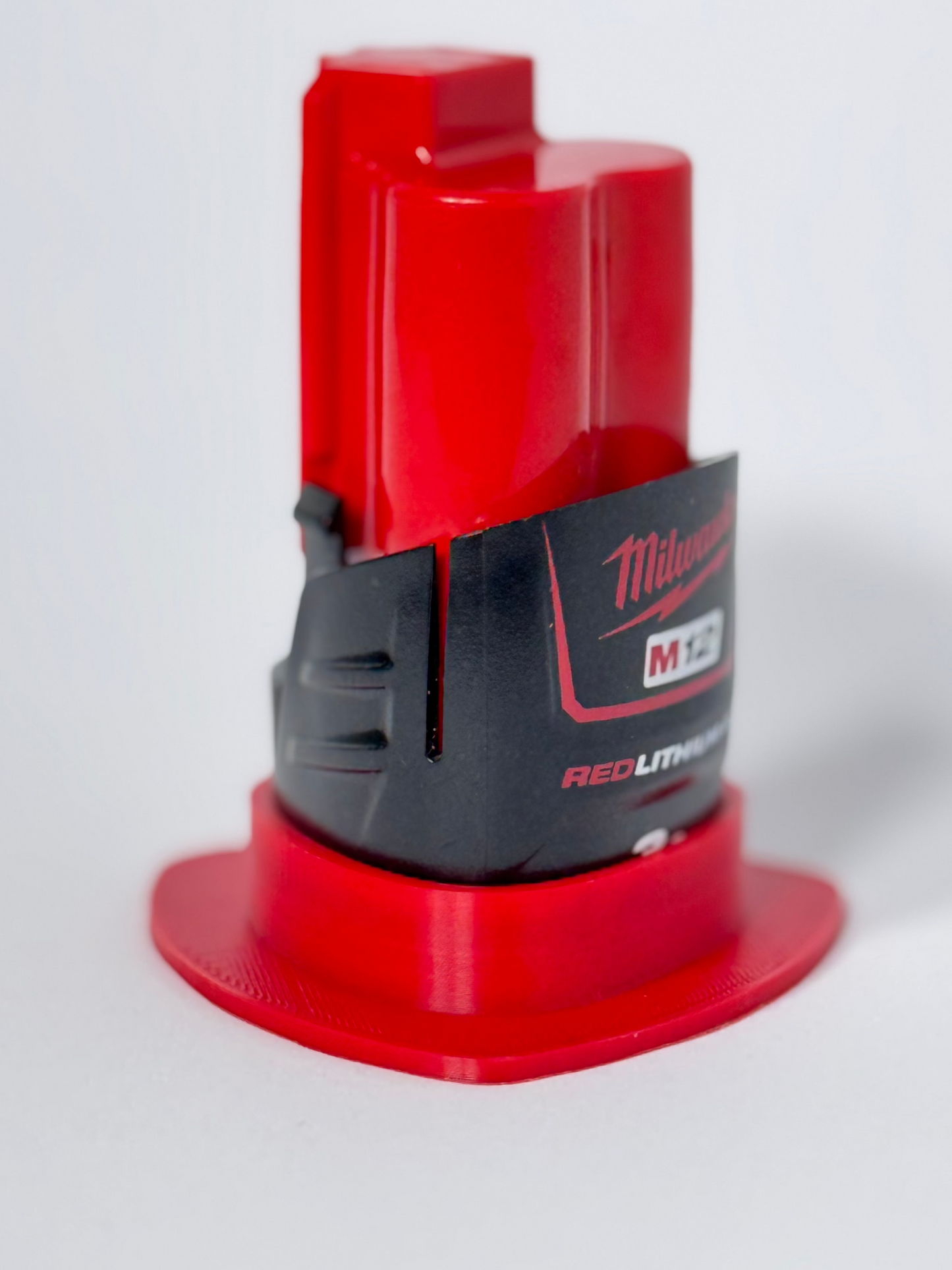 Milwaukee M12 magnetic battery mount for easy and secure storage on metal surfaces in your workspace.