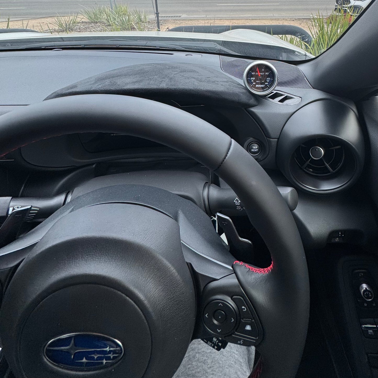 Front angle view of Toyota GR86 interior with aftermarket 52mm gauge pod