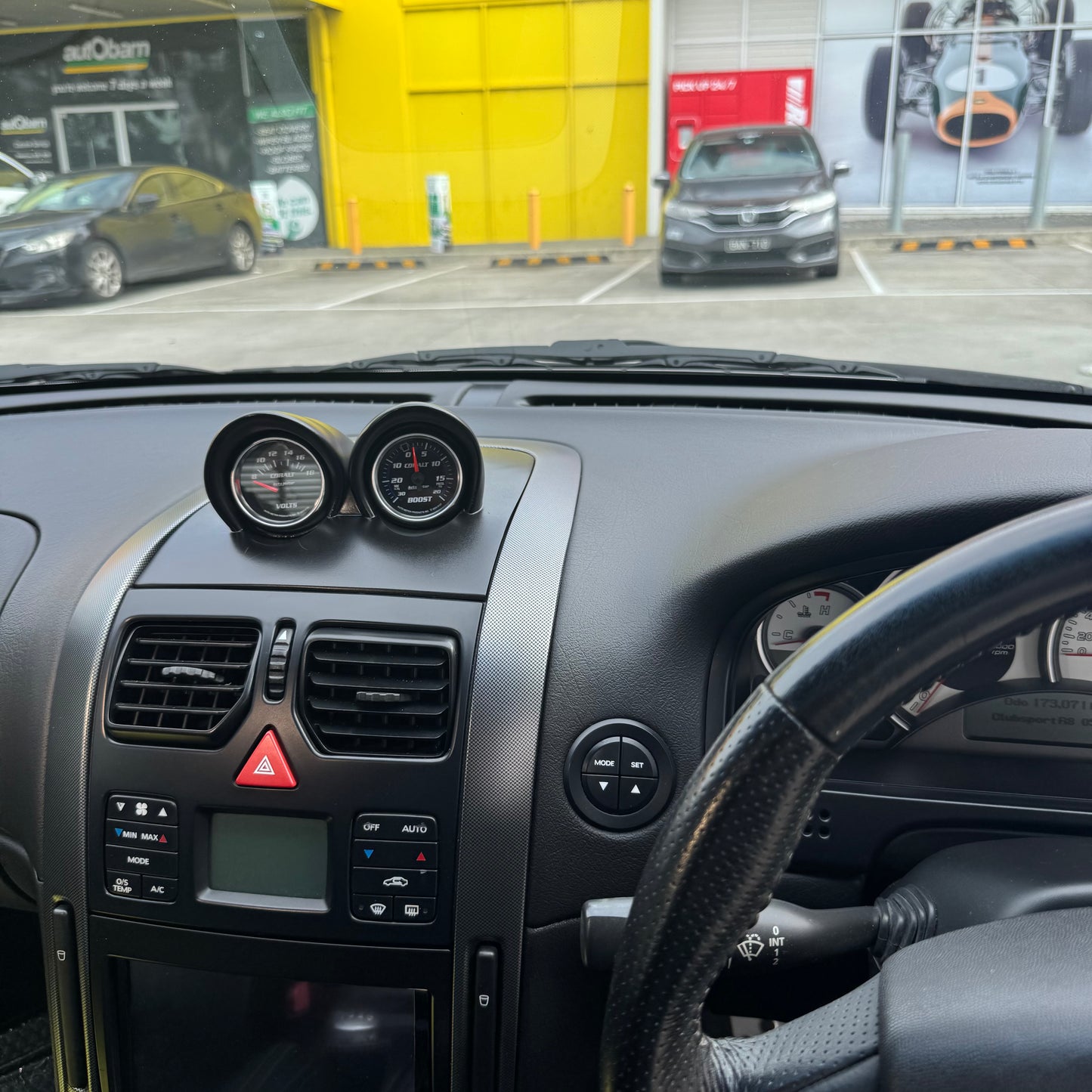 Painted satin black VY binnacle gauge pod installed in RHD dash, driver perspective showing clean OEM-style integration.