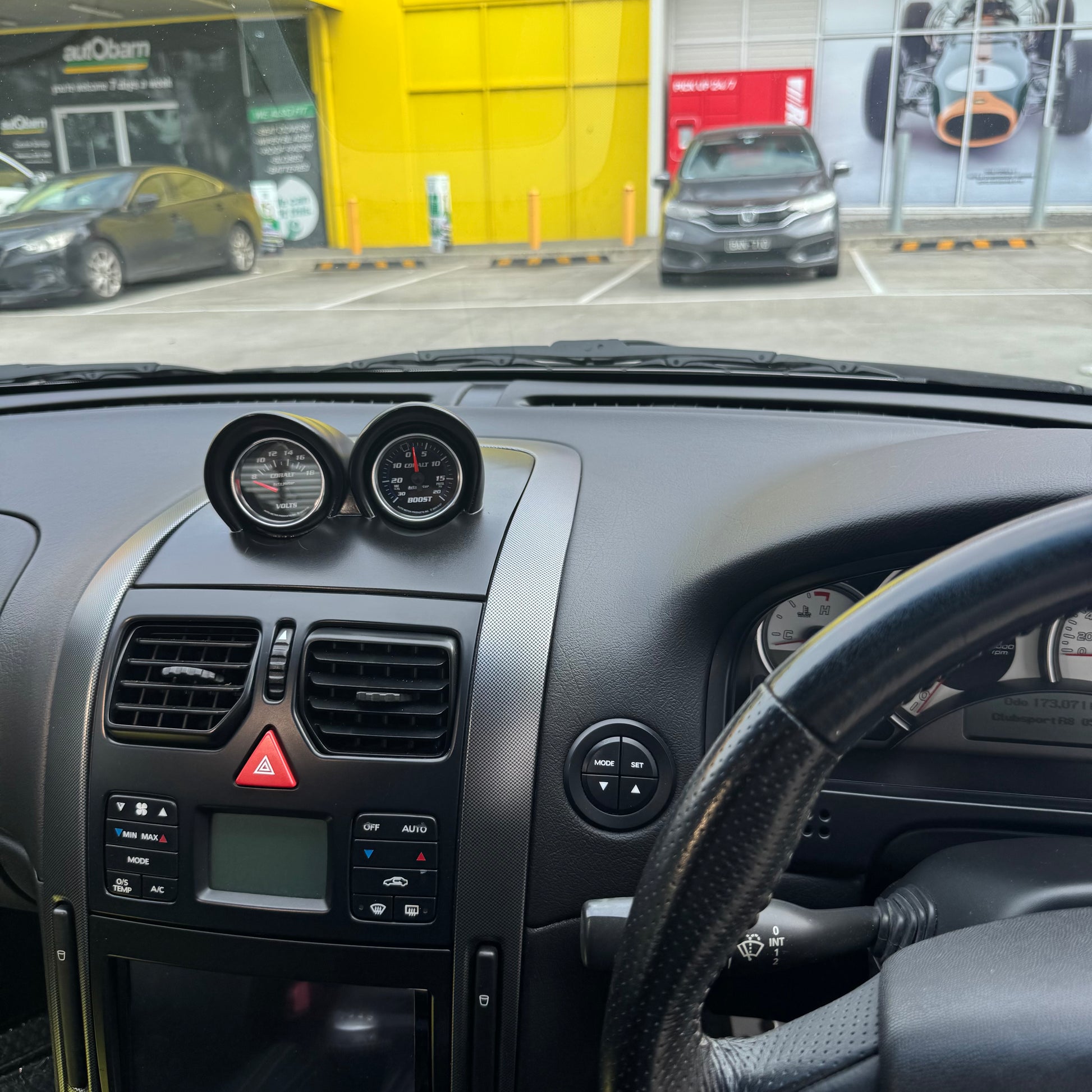 Painted satin black VY binnacle gauge pod installed in RHD dash, driver perspective showing clean OEM-style integration.