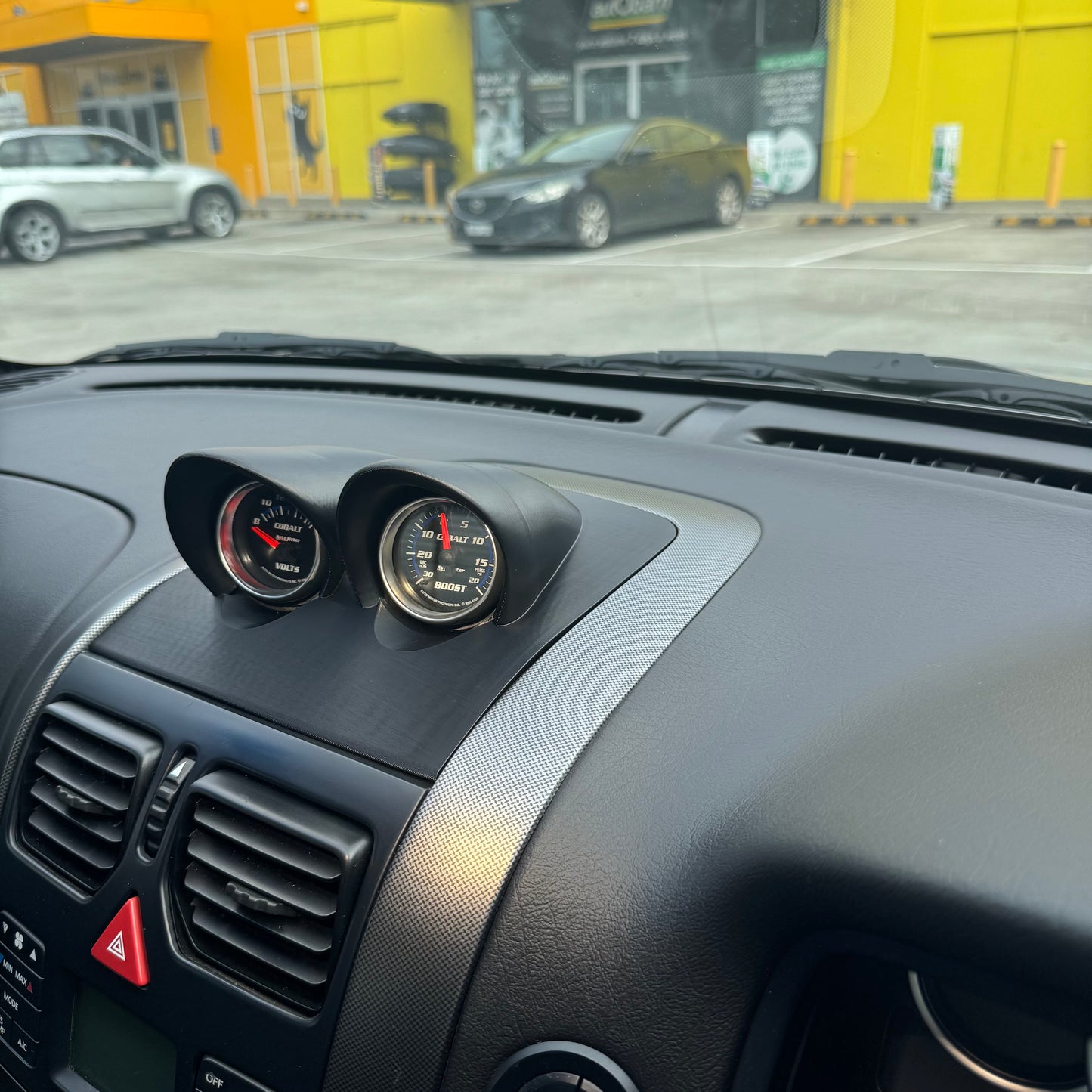Unpainted VY gauge pod installed in dash, angled view showing flush panel fitment and clean OEM+ integration.