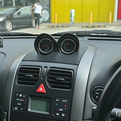 Unpainted black VY binnacle gauge pod installed in RHD dash, driver perspective showing OEM-style placement for 52mm gauges.