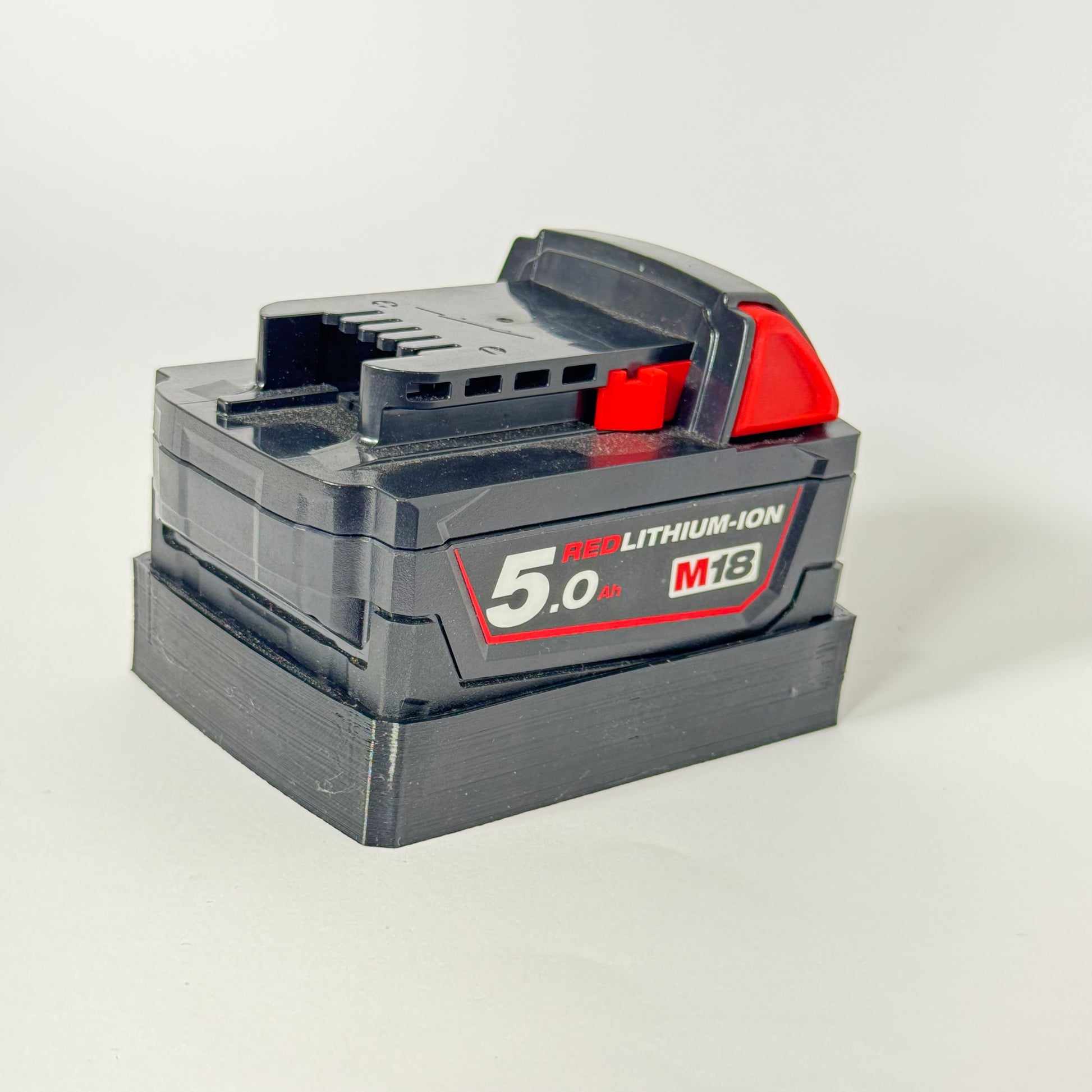 Magnetic battery mount for Milwaukee M18, made from durable TPU, perfect for tool organization and storage on metal surfaces.