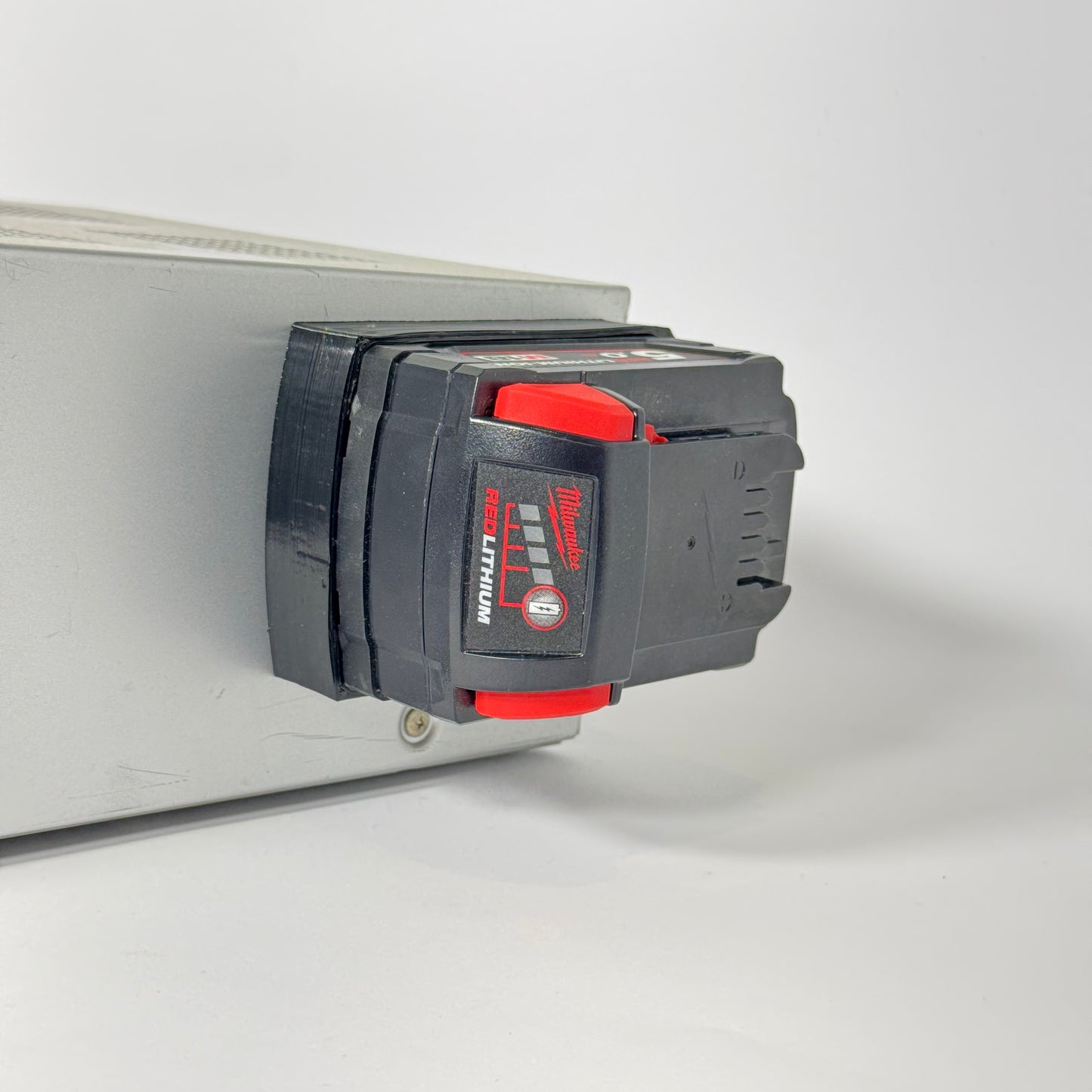 Milwaukee M18 magnetic base made from TPU, designed for secure storage and tool mounting on metal surfaces without shattering.